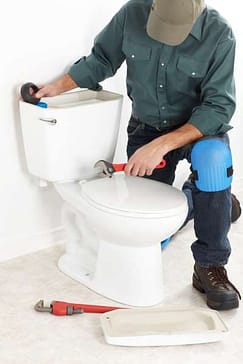Man fixing toilet. St. Louis toilet repair Fix St Louis
